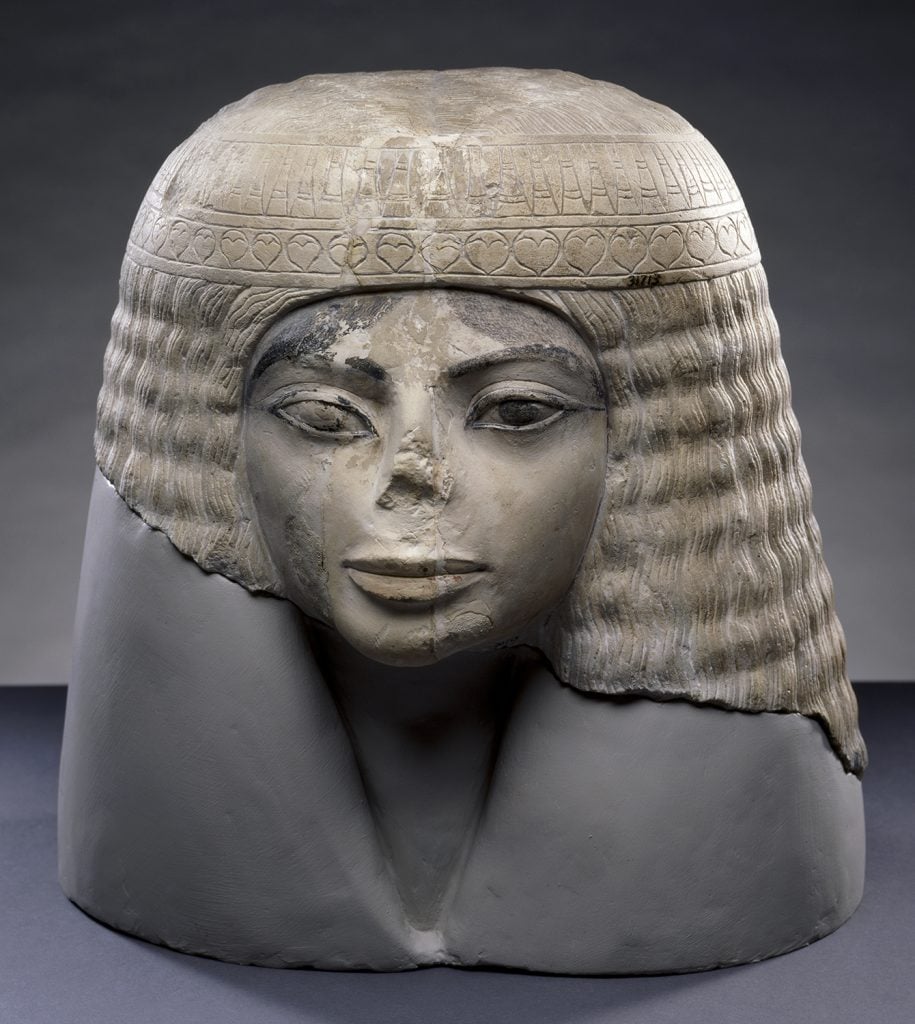 Ancient Egyptian statue with broken nose