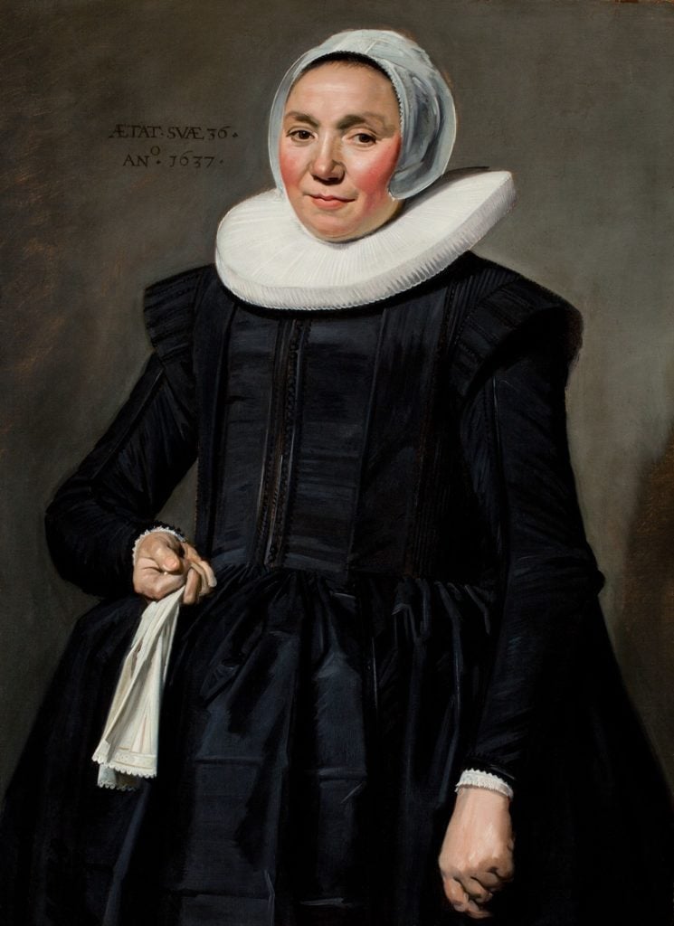 A painting of a woman in typical 17th-century Dutch clothes, with a ruff and cap. She holds gloves in one hand.